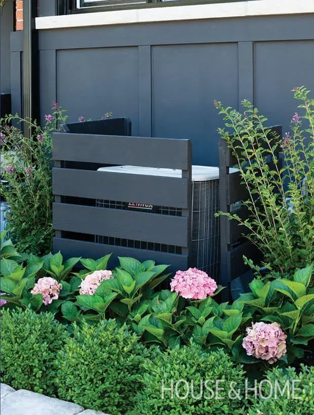 air conditioner covered w fence and plants